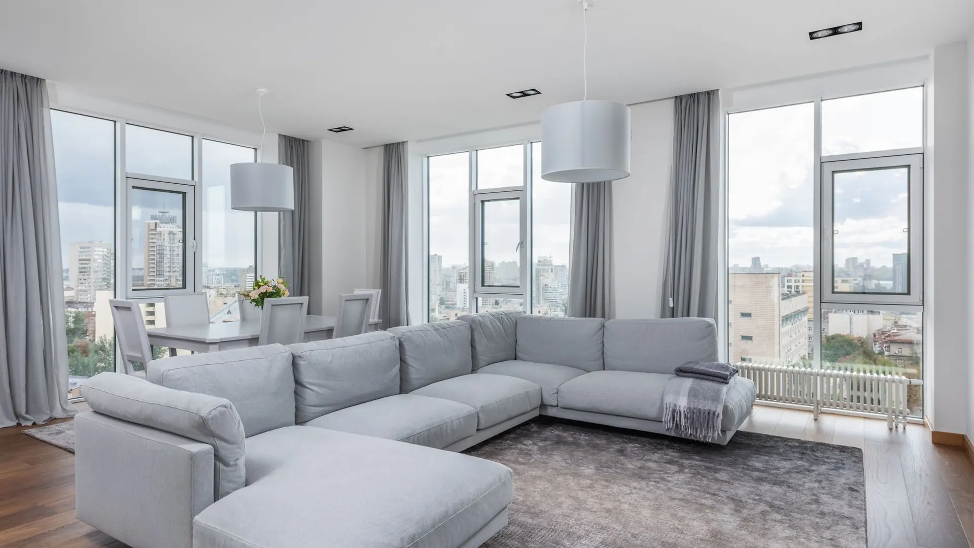 A spacious modern apartment and an illuminated villa exterior
